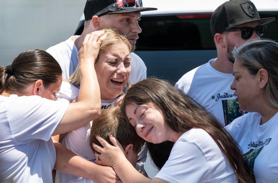 Brittoni Estrella, wife of Paul Chavez Jr., middle left, reacts to the video of her husband’s shooting by Modesto Police during a news conference to announce a wrongful death lawsuit for the fatal shooting of Chavez on July 14. With Estrella is Michael Chavez, top left, Alissia Hager, middle, Teresa Clutter, right, Roseanna Hager, left, and Martos Estrella. Photographed on Estrada Way in Modesto, Calif., on Tuesday, July 26, 2022.