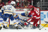 Buffalo Sabres goaltender Aaron Dell (80) stops a Detroit Red Wings left wing Tyler Bertuzzi (59) shot as John Hayden (15) defends in the first period of an NHL hockey game Saturday, Jan. 15, 2022, in Detroit. (AP Photo/Paul Sancya)