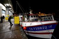 Fishermen unload box of fish at the fishing port in Port-en-Bessin-Huppain