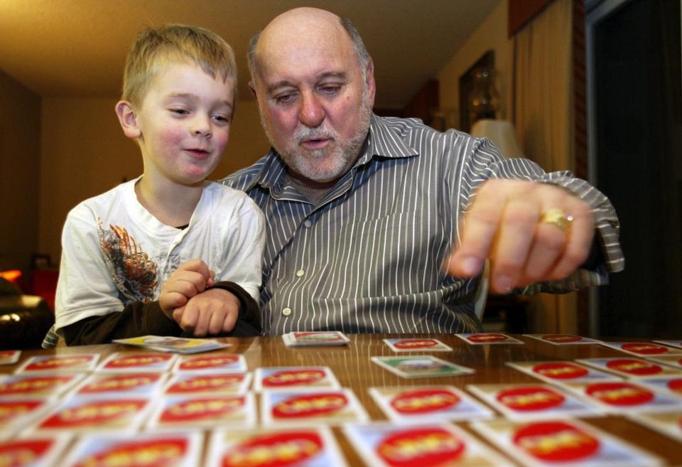 Former Port Orchard Mayor Lary Coppola holds his grandson, 5-year-old Bryce, during a game of Uno at the family's Port Orchard condominium in this 2009 file photo.
