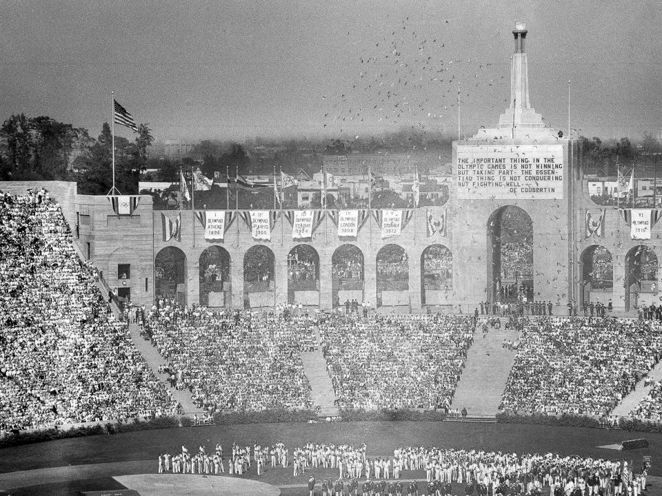 Doves are released during the opening ceremony for the Tenth Olympiad in Los Angeles on July 30, 1932. The athletes of various countries stand on the field. (AP Photo)