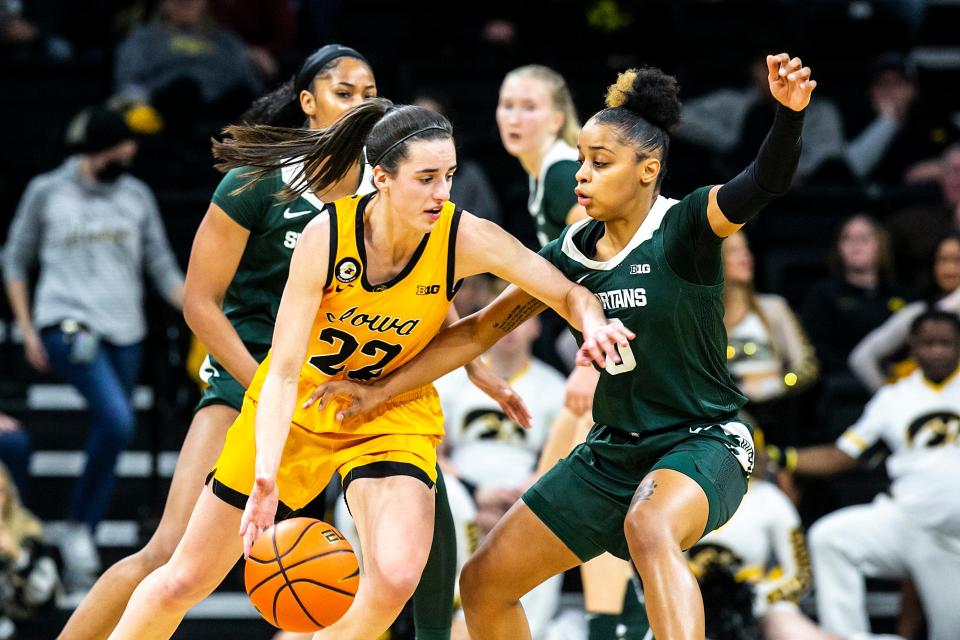 Iowa guard Caitlin Clark (22) drives to the basket as Michigan State guard DeeDee Hagemann (0) defends during a NCAA Big Ten Conference women's basketball game, Sunday, Dec. 5, 2021, at Carver-Hawkeye Arena in Iowa City, Iowa.