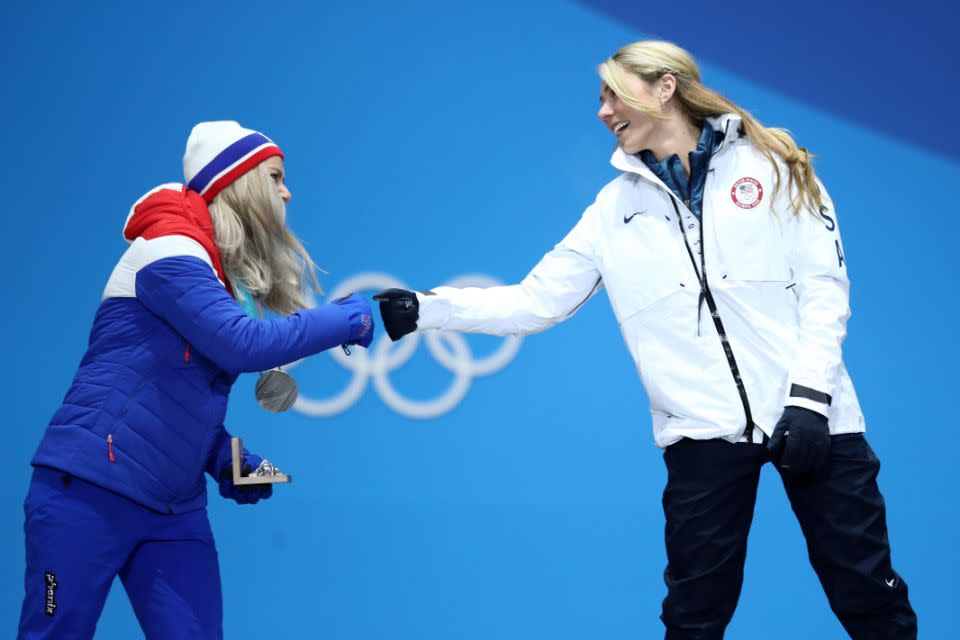 Gold medalist Mikaela Shiffrin and silver medalist Ragnhild Mowinckel, greet each other with a fist bump during the medal ceremony. Photo: Getty