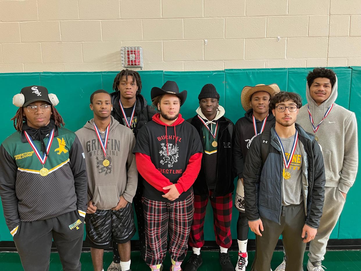 Richard Cash of Firestone, left, stands with Buchtel's James Neloms Jr., Firestone's Isaiah Moore, Buchtel's Davian Greenlee, Firestone's Braylon Brooks, Buchtel's Demetrion Duvall, Firestone's Ali Abdelrahim and Ellet's Cameron Allen after the City Series Wrestling Tournament at Firestone High School on Feb. 4, 2023.