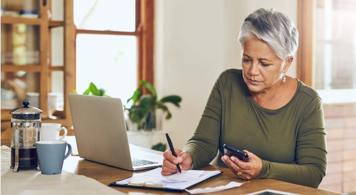 A retiree calculates her required minimum distribution (RMD).