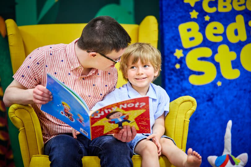 CBeebies presenter George Webster reading to five-year-old Alfie, from Chorlton