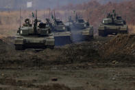 Japanese Ground-Self Defense Force (JGDDF) Type 90 tanks maneuver through a course during an annual exercise at the Minami Eniwa Camp Tuesday, Dec. 7, 2021, in Eniwa, Japan's northern island of Hokkaido. Dozens of tanks are rolling over the next two weeks on Hokkaido, a main military stronghold for a country with perhaps the world's most little known yet powerful army. (AP Photo/Eugene Hoshiko)