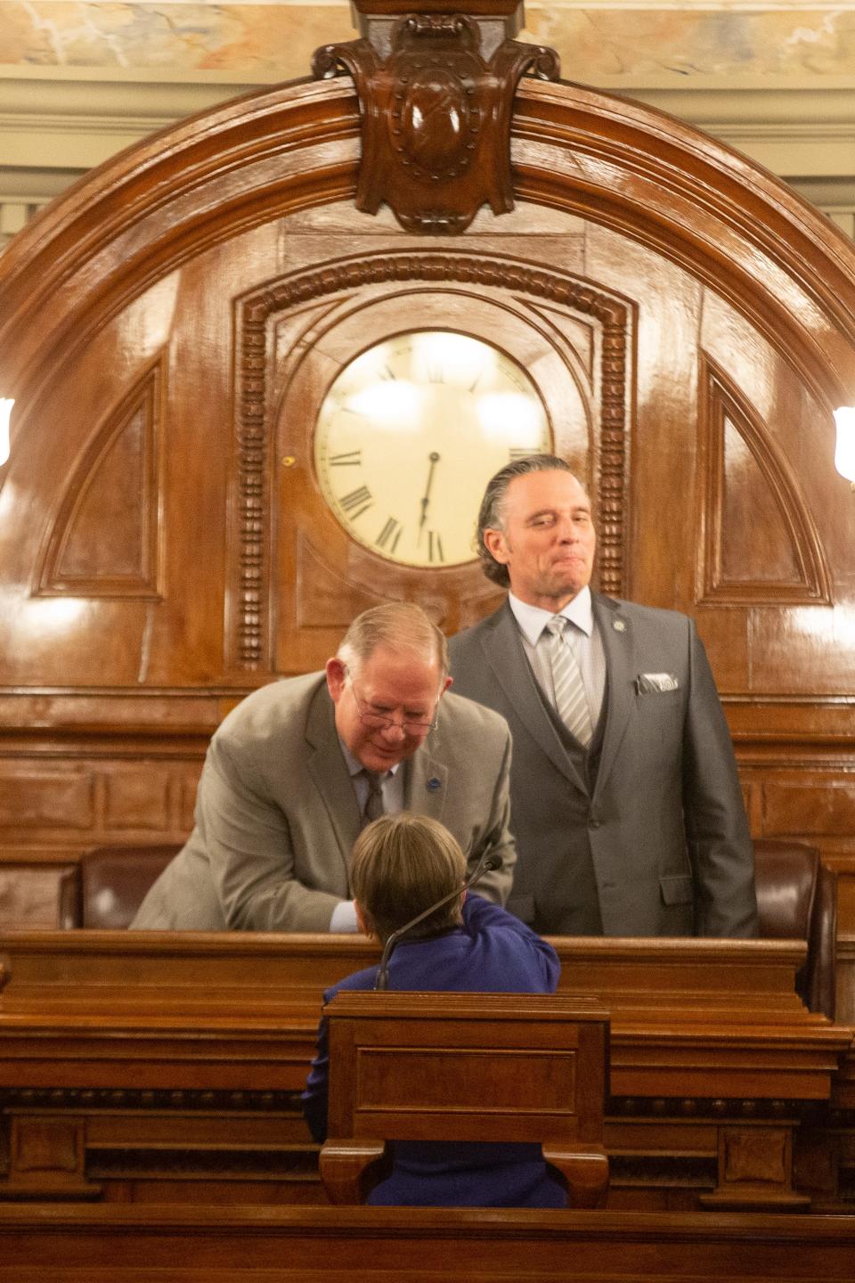 House Speaker Rep. Dan Hawkins, R-Wichita, shakes hands with Gov. Laura Kelly alongside Senate President Ty Masterson, R-Andover, at the start of the governor's 2023 State of the State address.