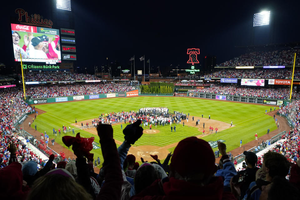 Philadelphia Phillies celebrate with the trophy after winning the baseball NL Championship Series in Game 5 against the San Diego Padres on Sunday, Oct. 23, 2022, in Philadelphia. (AP Photo/Matt Rourke)