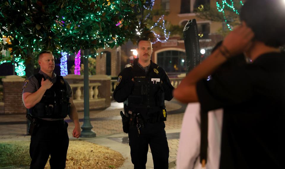 Oklahoma City police officers inform youths of the Bricktown curfew.