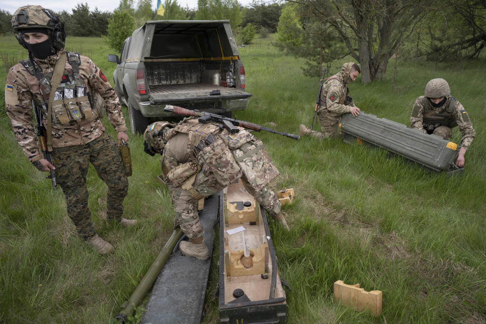 Members of a Ukrainian air-defense unit demonstrate their work near Kyiv on Monday, May 8, 2023. From camouflaged positions, the units dart out by truck into the farm fields around the capital, ready to take down enemy drones or missiles. Since Russia resumed regular air attacks on April 28, the units have a perfect score, intercepting every drone and missile shot at the capital. (AP Photo/Andrew Kravchenko)