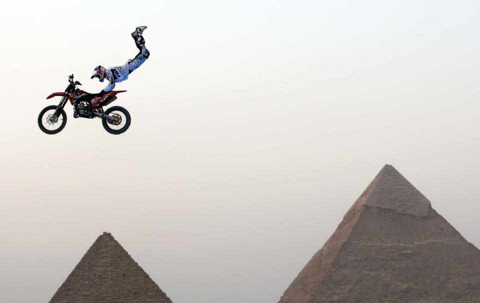 A biker performs in front of the Great Giza pyramids during Red Bull Fighters International Freestyle Motocross 2009 Exhibition Tour on the outskirts of Cairo April 10, 2009. REUTERS/Goran Tomasevic