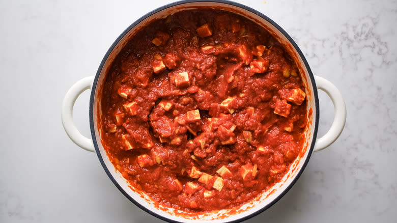 crushed tomatoes and tofu in Dutch oven