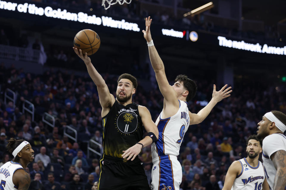 Golden State Warriors guard Klay Thompson (11) shoots against Washington Wizards forward Deni Avdija (9) during the first half of an NBA basketball game in San Francisco, Monday, Feb. 13, 2023. (AP Photo/Jed Jacobsohn)