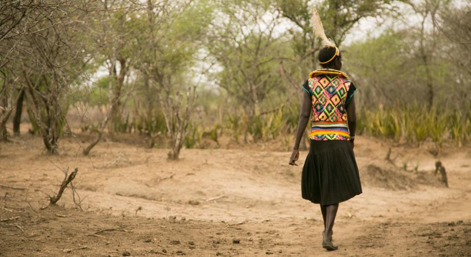 Cheposait Adomo walks in the bush in Kenya's West Pokot near where she was bitten repeatedly by a snake. (Photo: Zoe Flood)