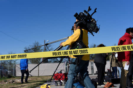 Members of the media move cameras around before the start of a news conference outside the scene of a blast at a FedEx facility in Schertz, Texas, U.S., March 20, 2018. REUTERS/Sergio Flores