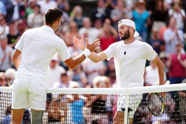 Jacob Fearnley shakes hands with Novak Djokovic