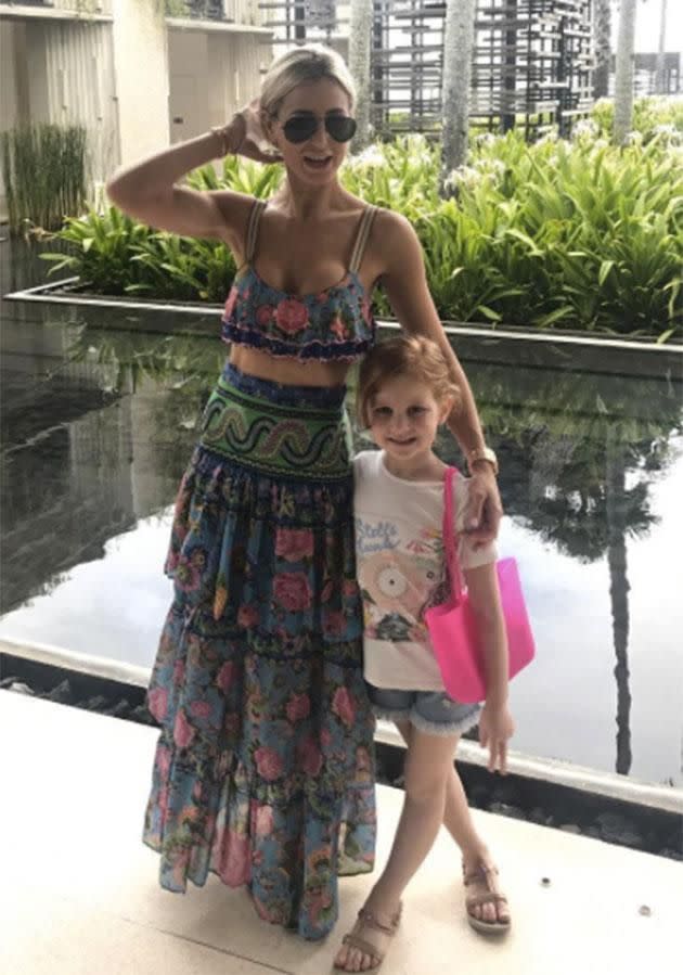 She threw a skirt on over the swimsuit for this cute snap with daughter Pixie.