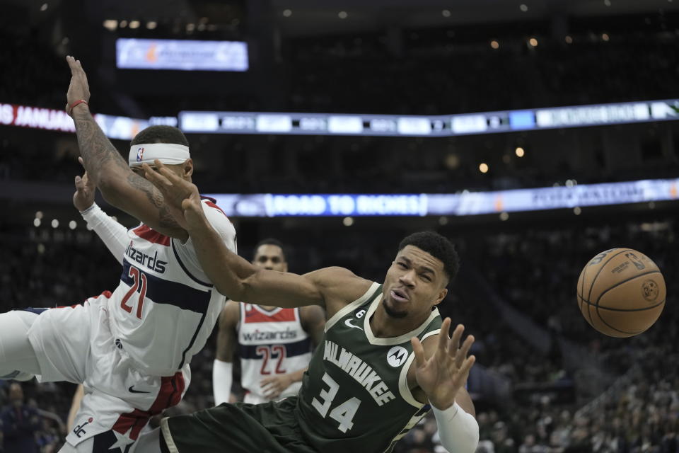 Washington Wizards' Daniel Gafford fouls Milwaukee Bucks' Giannis Antetokounmpo during the first half of an NBA basketball game Tuesday, Jan. 3, 2023, in Milwaukee. (AP Photo/Morry Gash)