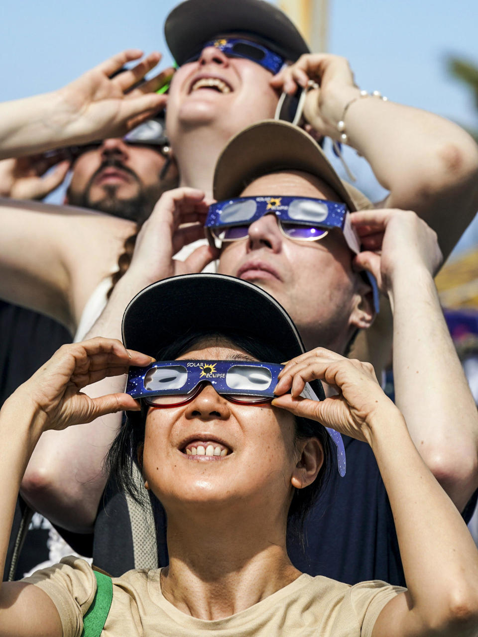 Image: People use special glasses to watch a total solar eclipse (Fernando Llano / AP)