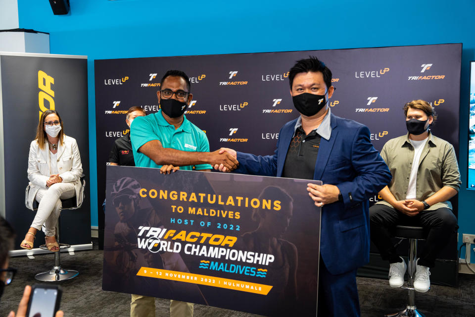 Elvin Ting (right), co-founder of Orange Room Asia, awarding the hosting rights for the TriFactor World Championship to Afrah, co-founder of Move Maldives. (PHOTO: TriFactor World Championship)