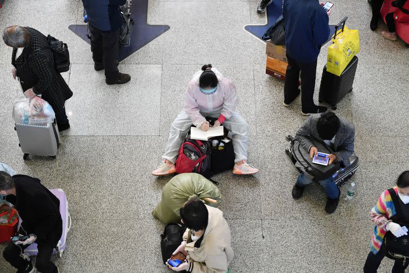 Travellers wait inside Hankou Railway Station in Wuhan