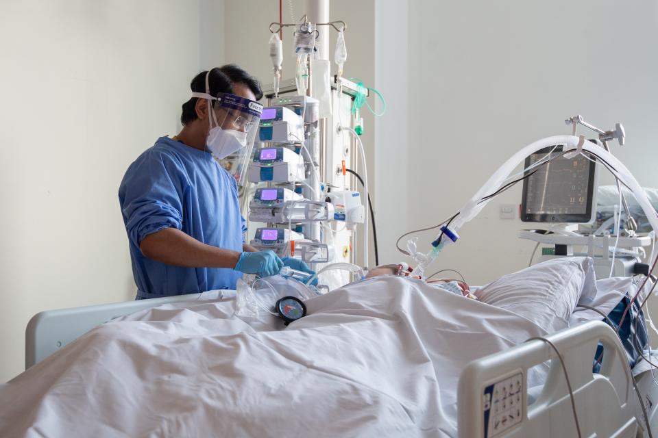 A nurse checks on a Covid-19 patient (PA Wire)