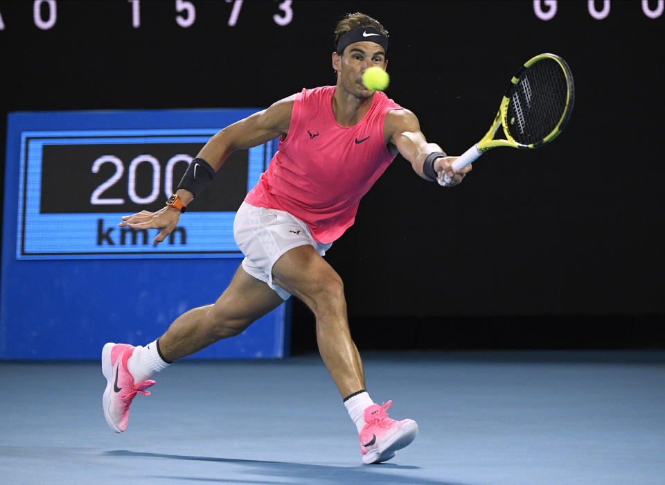 Spain's Rafael Nadal makes a forehand return to Austria's Dominic Thiem during their quarterfinal match at the Australian Open tennis championship in Melbourne, Australia, Wednesday, Jan. 29, 2020. (AP Photo/Andy Brownbill)