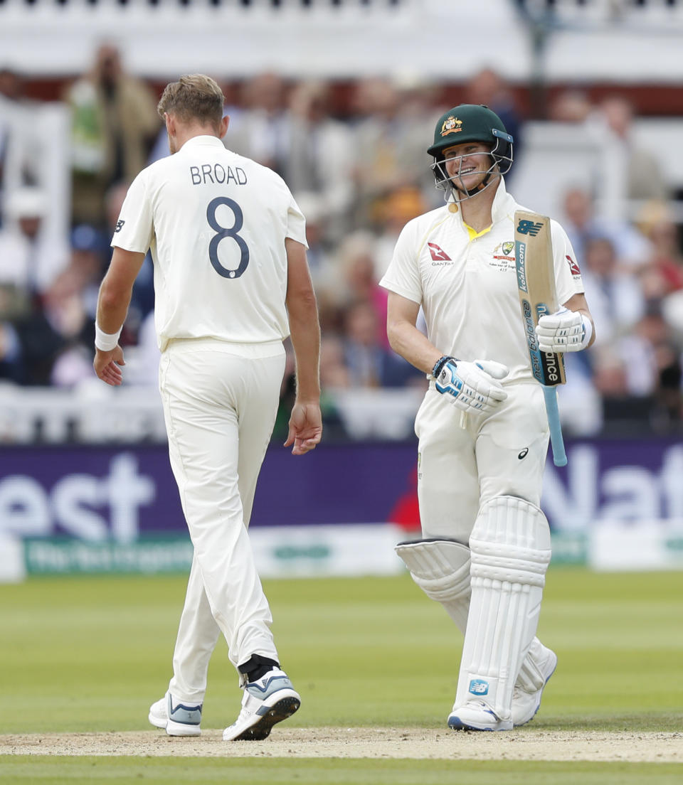 Australia's Steve Smith smiles at England's bowler Stuart Broad reacts on day four of the 2nd Ashes Test cricket match between England and Australia at Lord's cricket ground in London, Saturday, Aug. 17, 2019. (AP Photo/Alastair Grant)