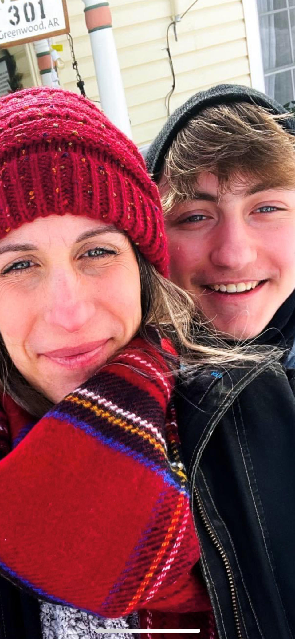 Dylan Brandt, 15, and his mom pose for a photos in Greenwood, Arkansas on Feb. 18, 2021. Dylan is one of hundreds of transgender youth in Arkansas who could have their hormone therapy cut off under a new law banning gender confirming treatments for minors. Opponents have vowed to challenge the law in court before it takes effect later this year. (Joanna Brandt via AP)