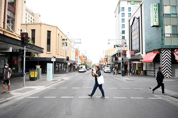 A woman crosses Hindley Street in Adelaide.