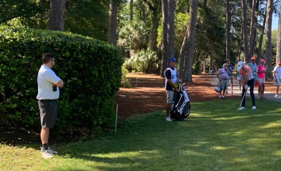 Chad Dewing watches as a golfer take a shot mere feet from his father-in-law’s backyard in Sea Pines. Sebastian Lee
