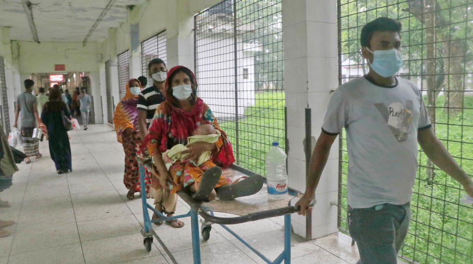 A patient is transported on a stretcher at the Medical College Hospital in Rajshahi, 254 kilometers (158 miles) north of the capital, Dhaka, Bangladesh, June 16, 2021. Rajshahi has become one of the latest hotspots for the deadlier delta variant of the coronavirus. Bangladeshi authorities are increasingly becoming worried over the quick spread of coronavirus in about two dozen border districts close to India amid concern that the virus could devastate the crowded nation in coming weeks. (AP Photo/ Kabir Tuhin)