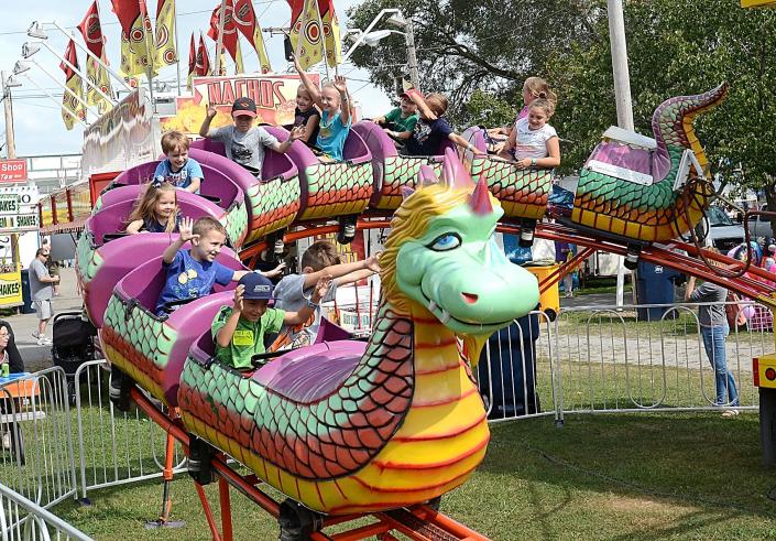 Youngsters ride the Dragon Wagon in August 2017 during the Canfield Fair.