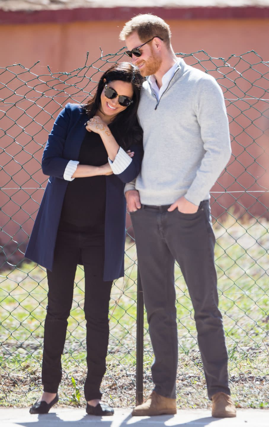 <p>Meghan playfully leans on her husband while they visit a local secondary school in Asni, Morocco <a href="https://www.townandcountrymag.com/society/tradition/g26364847/prince-harry-and-meghan-markle-morocco-2019-visit-photos/" rel="nofollow noopener" target="_blank" data-ylk="slk:during their official royal visit;elm:context_link;itc:0;sec:content-canvas" class="link ">during their official royal visit</a>. </p>