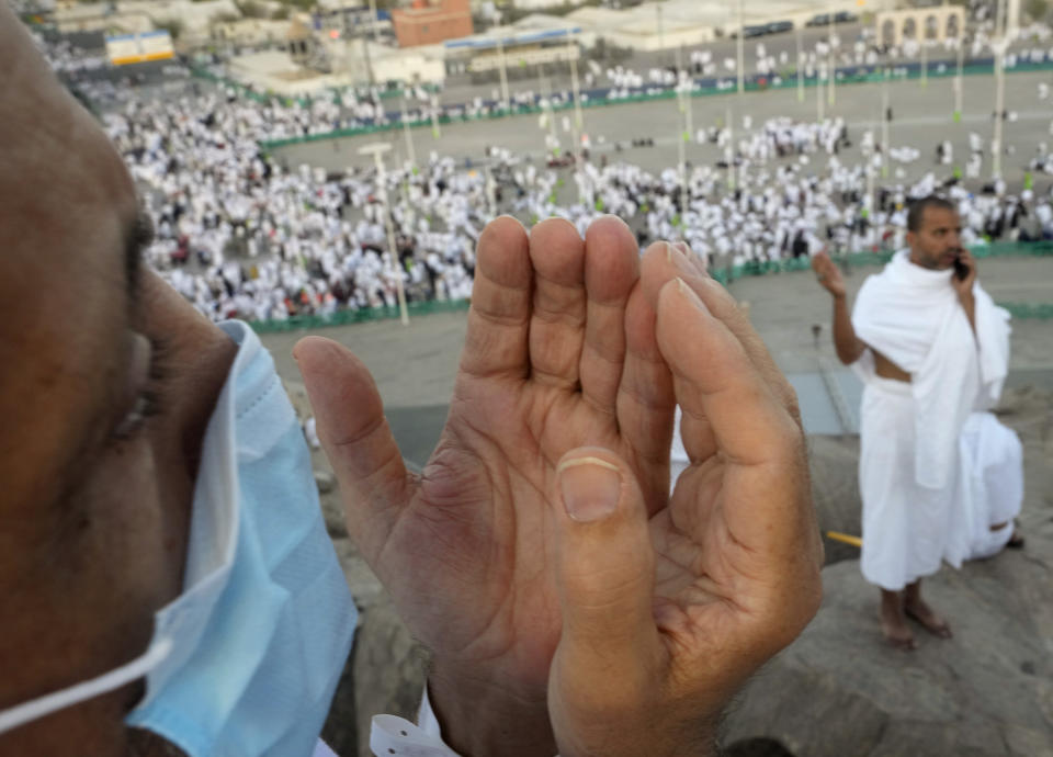 A Muslim pilgrim prays on the rocky hill known as the Mountain of Mercy, on the Plain of Arafat, during the annual hajj pilgrimage, near the holy city of Mecca, Saudi Arabia, Friday, July 8, 2022. One million pilgrims from across the globe amassed on Thursday in the holy city of Mecca in Saudi Arabia to perform the initial rites of the hajj, marking the largest Islamic pilgrimage since the coronavirus pandemic upended the annual event, a key pillar of Islam. (AP Photo/Amr Nabil)