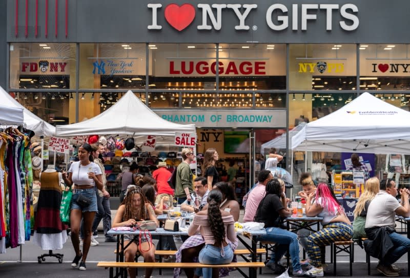 FILE PHOTO: People shop at a street fair near Times Square in New York City