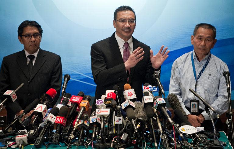 Malaysia's Minister of Defence and Acting Transport Minister Hishammuddin Hussein (C) answers questions from journalists during a press conference at a hotel near Kuala Lumpur International Airport (KLIA) in Sepang on March 13, 2014