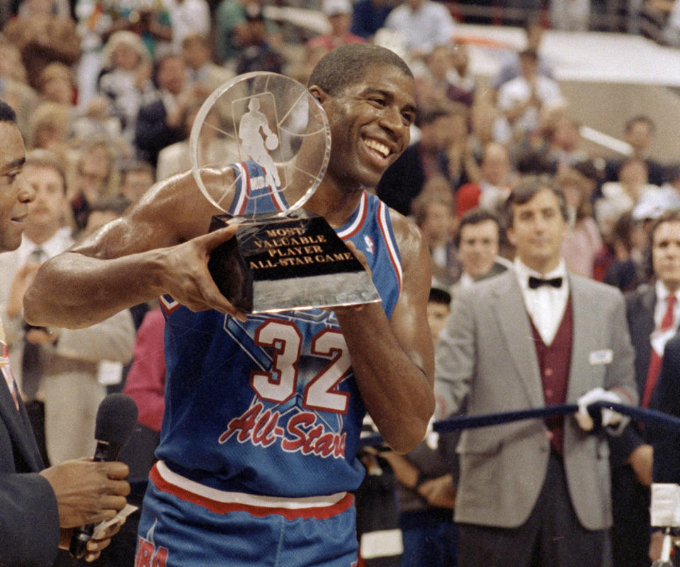 Magic Johnson smiles with the 1992 NBA All-Star Game Most Valuable Player trophy. (AP)