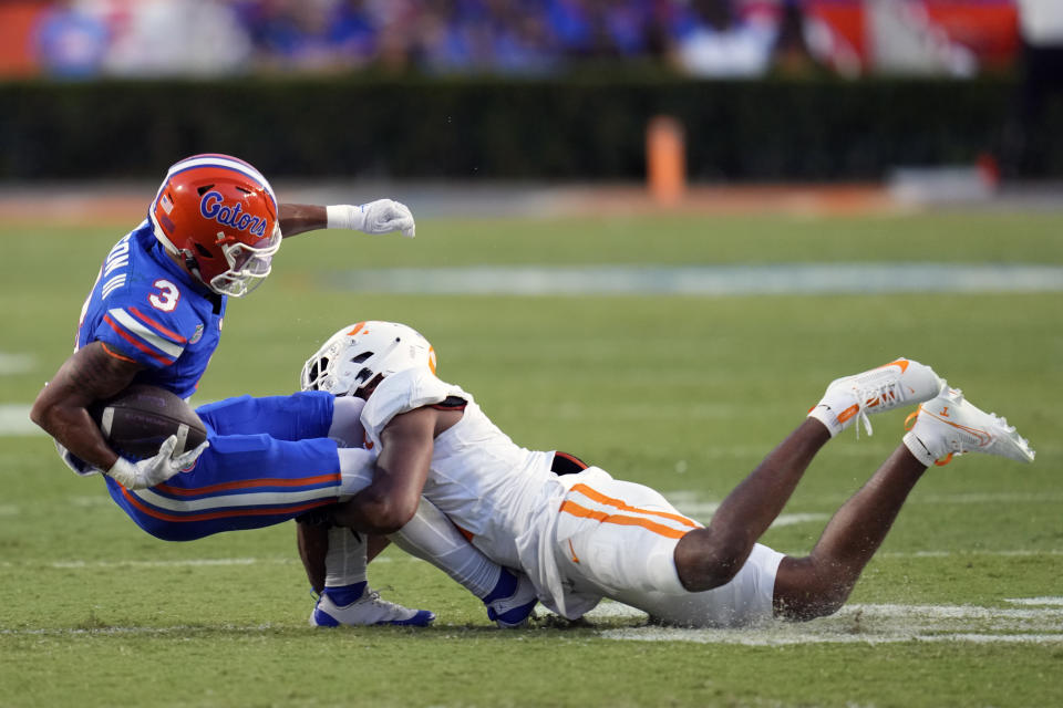 Florida wide receiver Eugene Wilson III (3) is stopped by Tennessee defensive back Gabe Jeudy-Lally after a reception during the first half of an NCAA college football game, Saturday, Sept. 16, 2023, in Gainesville, Fla. (AP Photo/John Raoux)