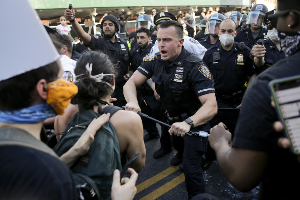 New York Police officers push back protesters during a demonstration Saturday, May 30, 2020, in the Brooklyn borough of New York. Protests were held throughout New York over the death of George Floyd, a black man who was in police custody in Minneapolis. Floyd died after being restrained by Minneapolis police officers on Memorial Day. (AP Photo/Seth Wenig)