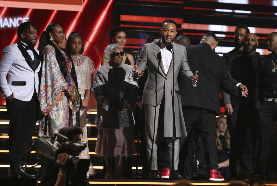 John Legend, center, DJ Khaled and members of Nipsey Hussle's family accept the award for best rap/sung performance at the 62nd annual Grammy Awards on Sunday, Jan. 26, 2020, in Los Angeles. (Photo by Matt Sayles/Invision/AP)