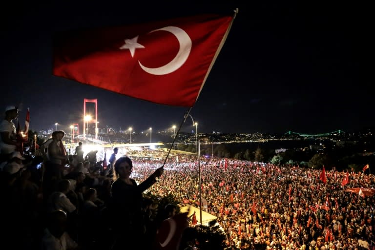 Pro-Erdogan supporters wave a Turkish national flag during a rally at the Bosphorus bridge in Istanbul on July 21, 2016