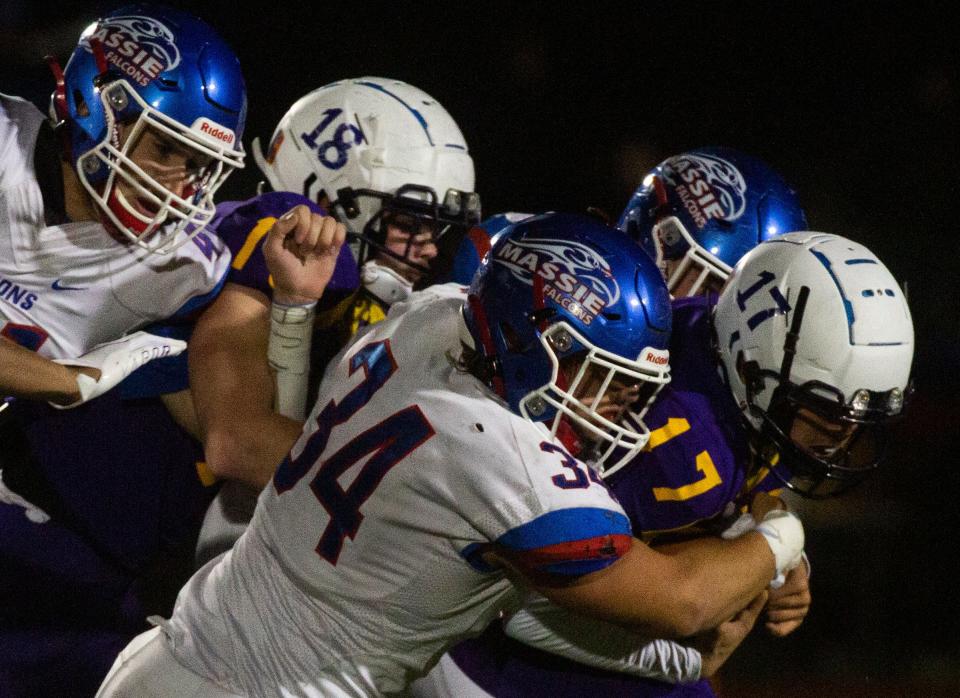 Clinton-Massie's Colton Trampler tackles K.J. Benedict of Bloom-Carroll at Jonathan Alder High School in Plain City, Ohio on November 26, 2021.