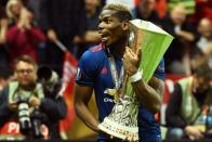 Manchester United's Paul Pogba celebrates with the UEFA Europa League trophy after winning their match against Ajax Amsterdam on May 24, 2017 at the Friends Arena in Solna outside Stockholm