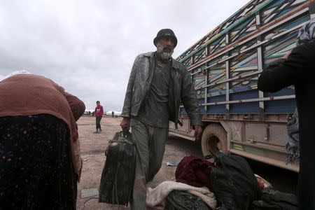 Internally displaced Syrian people who fled Raqqa city get out of a truck into a camp in Ain Issa, Raqqa Governorate, Syria April 1, 2017. REUTERS/Rodi Said