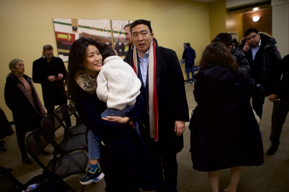 MT. PLEASANT, IA - JANUARY 24:  Democratic presidential candidate Andrew Yang and wife, Evelyn, carry their sons to the campaign bus following a rally at Iowa Wesleyan University on January 24, 2020 in Mt. Pleasant, Iowa. Yang continues his 17 day bus tour through Iowa today with five town halls along the southeastern state line. (Photo by Mark Makela/Getty Images)