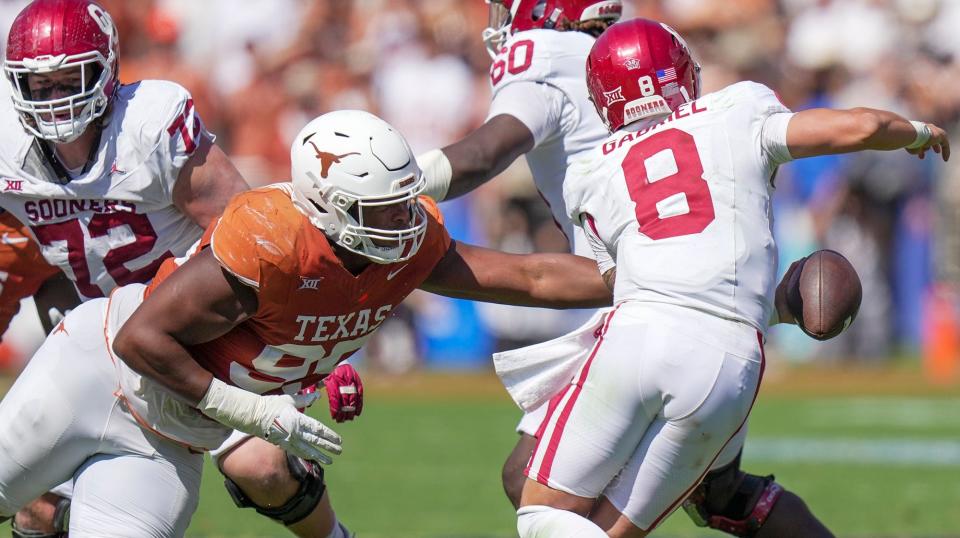 Texas defensive tackle Alfred Collins tries to reach Oklahoma quarterback Dillon Gabriel during their 2023 game at the Cotton Bowl. After spending years as a backup in the rotation, Collins will be a full-time starter this season.