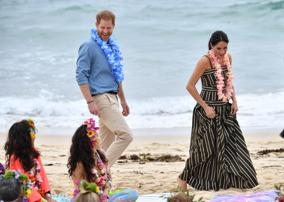 One of the most confusing Royal Fashion rules of all time? That you can't ditch your shoes on the beach during official royal visits, especially if you're a female member of the royal family. Kate Middleton <a rel="nofollow noopener" href="https://www.express.co.uk/news/royal/1033591/Meghan-Markle-prince-harry-royal-protocol-sydney-Bondi-beach-australia-tour-shoes" target="_blank" data-ylk="slk:reportedly;elm:context_link;itc:0;sec:content-canvas" class="link ">reportedly</a> kept her shoes on at Manly Beach in 2014, and Princess Diana did the same at NSW Beach in Terrigal in 1983. As she is wont to do, Meghan totally broke protocol and ditched tradition, kicking off her shoes at Bondi Beach mid-October. Can you blame her?