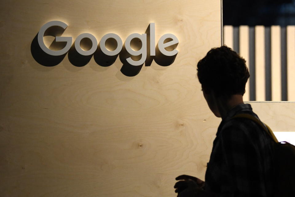 A woman passes the logo from the web search engine provider Google during the digital society festival 're:publica', at the Arena Berlin in Berlin, Germany June 9, 2022. REUTERS/Annegret Hilse
